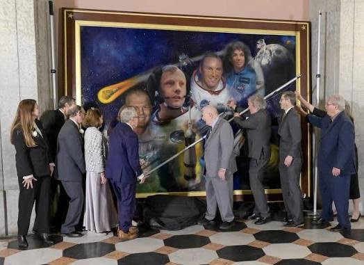 The painting being hung in the Ohio Statehouse Rotunda, with Governor Mike DeWine, Gene Kranz, and other dignitaries present